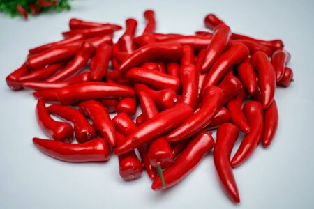 Sweet red pepper kapi, three peppers on white wooden tableの写真素材