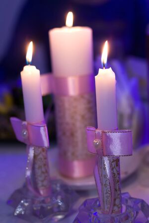 Burning candle and Christmas decoration over snow and wooden background, elegant low-key shot with festive mood, candle, christmas, backgroundの写真素材