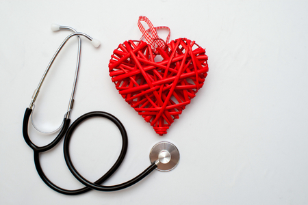 Medicine. Pressure sensor, heart shape, stethoscope and dollars on a wooden backgroundの写真素材