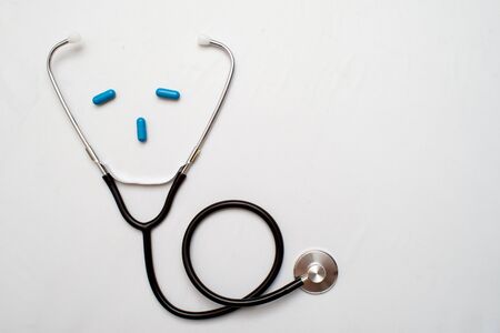 Medicine. Pressure sensor, heart shape, stethoscope and dollars on a wooden backgroundの写真素材