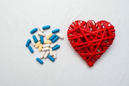 Medicine. Pressure sensor, heart shape, stethoscope and dollars on a wooden backgroundの写真素材