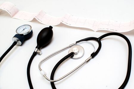 Stethoscope on the electrocardiogram graph top view, professional
