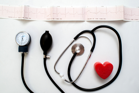 Red heart and a stethoscope on desk cardiac, closeup