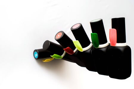 Bottles of nail polish on a colorful wooden table, makeの写真素材