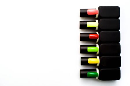 Bottles of nail polish on a colorful wooden table, makeの写真素材