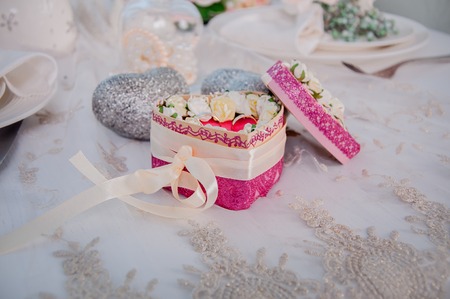 The bride and groom rings on the decorated tableの写真素材