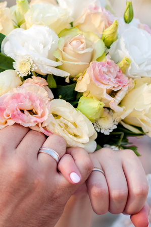 Hands of groom and bride with rings.の写真素材