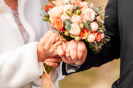 Bride and groom with bouquetの写真素材