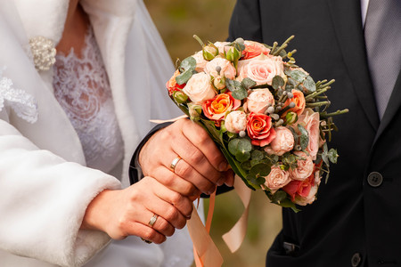 Bride and groom with bouquetの写真素材