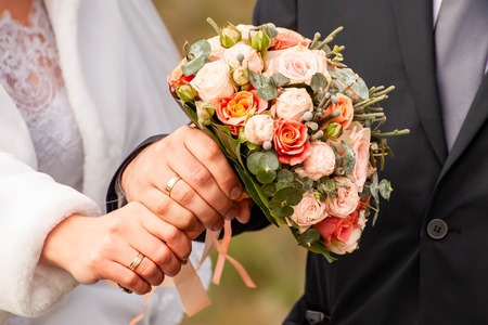 Bride and groom with bouquetの写真素材