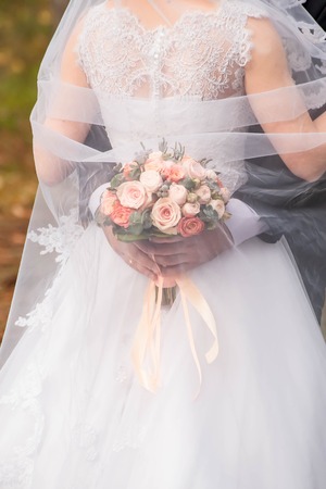 Bride and groom with bouquetの写真素材