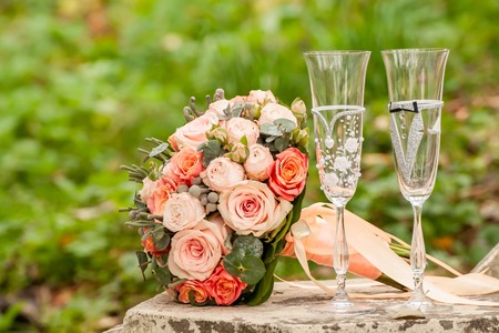 Bride and groom champagne glass with bouquetの写真素材