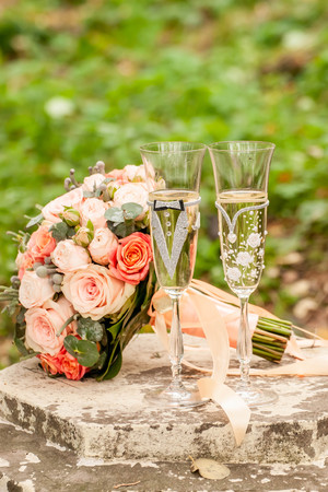 Bride and groom champagne glass with bouquetの写真素材