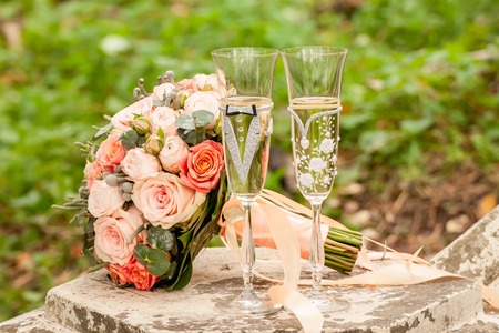 Bride and groom champagne glass with bouquetの写真素材