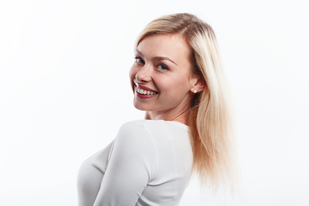Beautiful woman smiling face close up studio on white.の写真素材