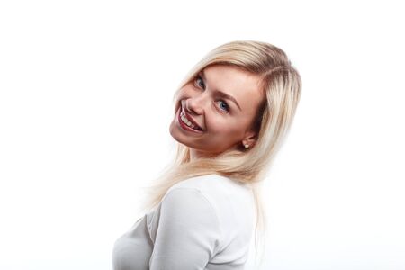 Beautiful woman smiling face close up studio on white.の写真素材