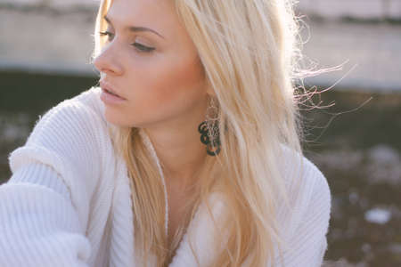 Girl in sweater close-up portrait outdoor. Warm fall.の写真素材