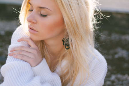 Girl in sweater close-up portrait outdoor. Warm fall.の写真素材