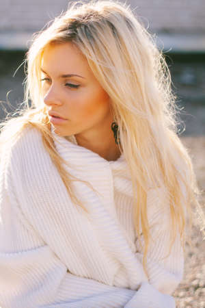 Girl in sweater close-up portrait outdoor. Warm fall.の写真素材
