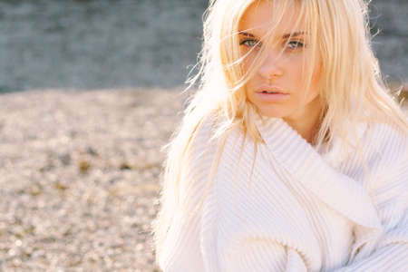 Girl in sweater close-up portrait outdoor. Warm fall.の写真素材