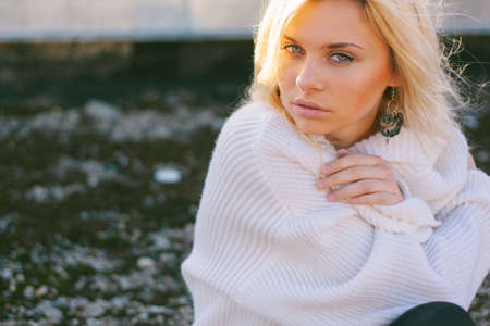 Girl in sweater close-up portrait outdoor. Warm fall.の写真素材