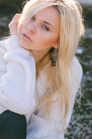 Girl in sweater close-up portrait outdoor. Warm fall.の写真素材