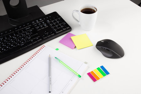 Office workplace table with supplies and coffee cup. Flat lay. Top view with space for your textの写真素材