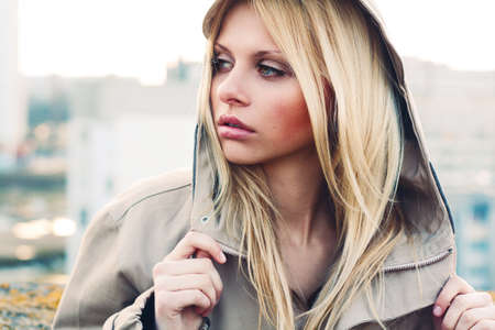 Outdoor portrait of young sensual woman in the hood closeup.の写真素材