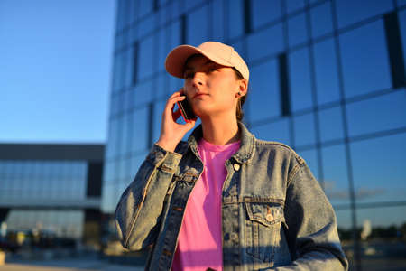 business, communication, technology and people concept - businesswoman calling on smartphone in city. High quality photo.の写真素材