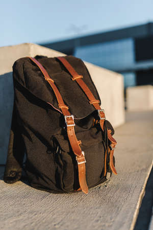 Hipster backpack closeup. View from front tourist traveler bag on urban background.の写真素材