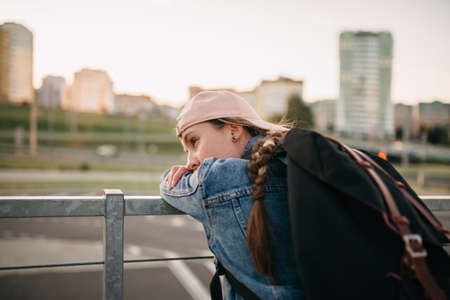 Tourist admires the overview of the sights of the city. Woman with backpack enjoy beautiful city view, traveler mock up top of the city.の写真素材