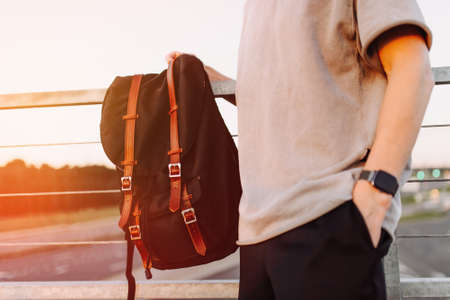 Hipster backpack closeup. View from front tourist traveler bag on urban background.の写真素材