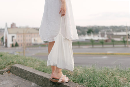 Woman Holding Blank White Eco Bag. Stop Plastic Pollution. Young woman with cotton bag on city...