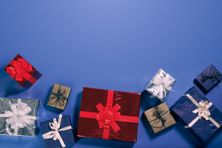 Colorful gift boxes beautifully arranged on a blue background for special celebrationsの写真素材