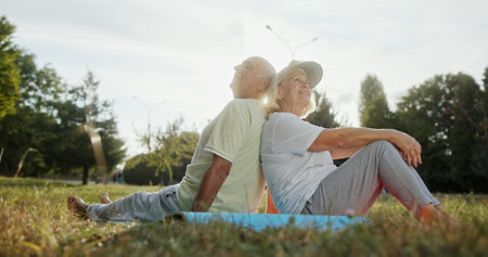 An Elderly Couple Mindfully Practicing Relaxation Techniques in a Beautiful Outdoor Space
