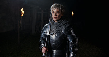 A Courageous Knight clad in Dark Armor Stands Vigilantly as a Guard against the Nightの写真素材