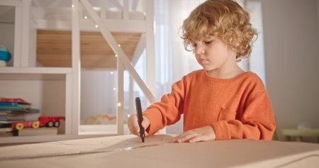 A Creative Child Engaged in Artistic Activities at Home Utilizing Various Markers for Funの写真素材