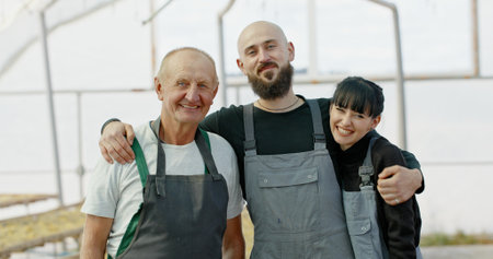 A Committed and Dedicated Team of Farmers Collaborating Together in a Lush Greenhouse Environment