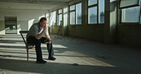 A Thoughtful Man Deep in Contemplation in a Space that has been Completely Abandoned