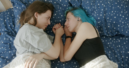 A Truly Intimate and Heartfelt Moment Shared Between Two Young Women Relaxing Together in Bed