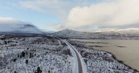 Snow-Covered Road Stretching into Arctic Landscape