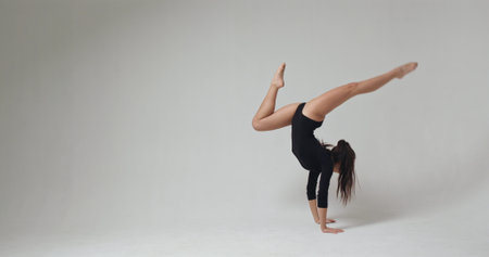 Modern style dancer turning and posing in front of the camera. Slow motion.
