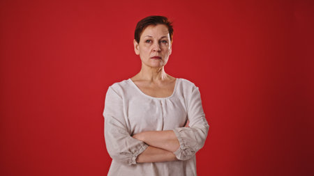 Cheerful Greeting: Mature Woman on Red Background
