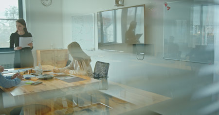Participating in a Collaborative Team Meeting within a Modern Office Environment Setting