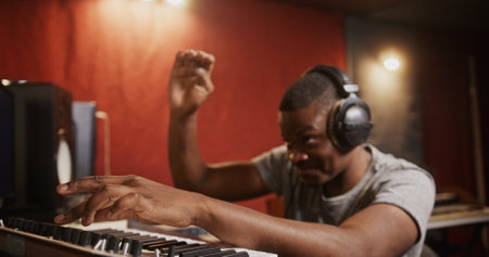 A Talented Musician Creating Unique Beats in a Professional Recording Studio Sessionの写真素材