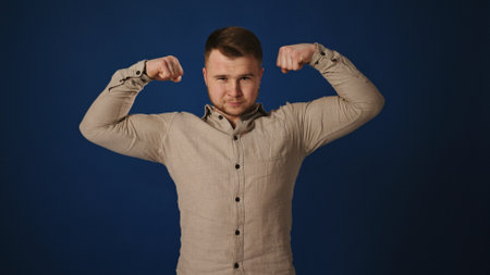 Confident Flex: Man Showcasing Biceps with a Wink