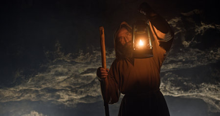 A mysterious figure is holding a glowing lantern while standing in the stormy night atmosphere