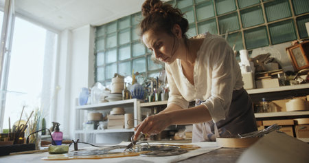 Glass Artist Soldering Connections in Floral Glass Mirror