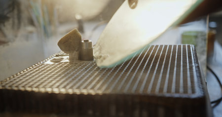 Close-Up of Glass Grinding in Artisan Workshop with Sunlight