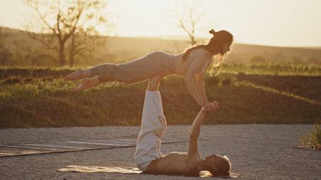 Dynamic Yoga Partners pose in a beautiful Sunset Pose, capturing harmony and connection